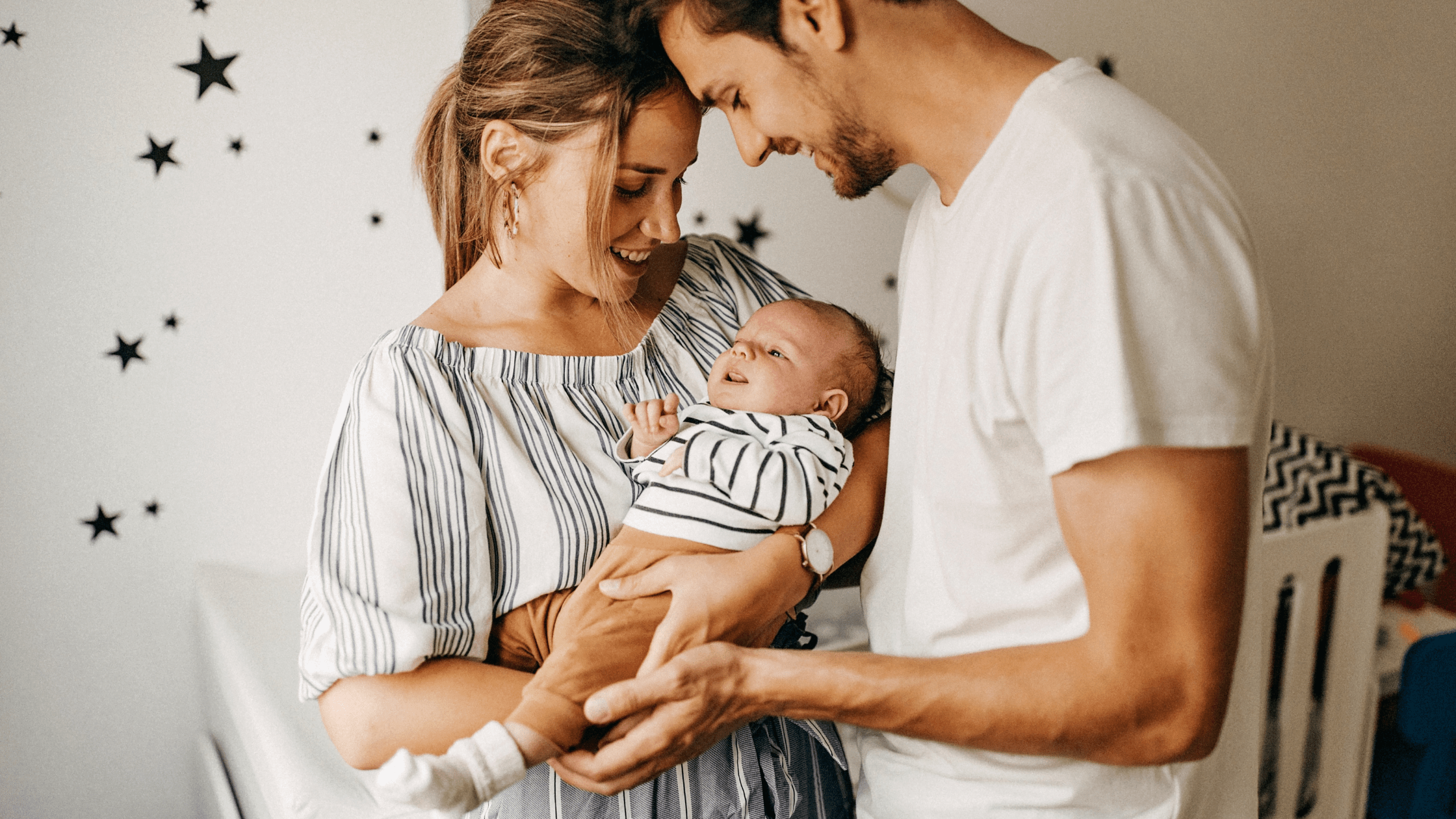 New family embracing their new baby