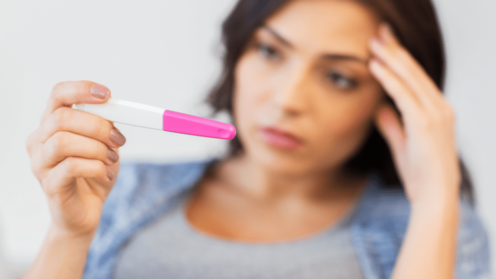 Woman looking at pregnancy test